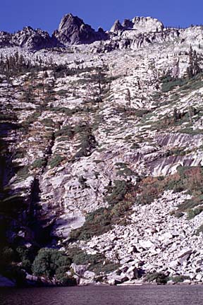 photo of lake with granite slope in the background