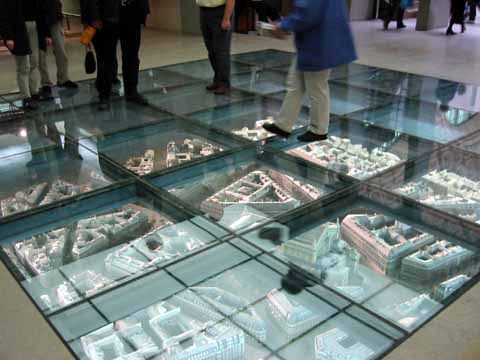 Photo, people walking on glass cover above street model