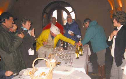 Photo of group at serving table with wine
