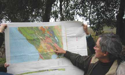 Photo of David pointing out features on a geologic map
