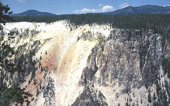photo of volcanic cliffs in canyon in background