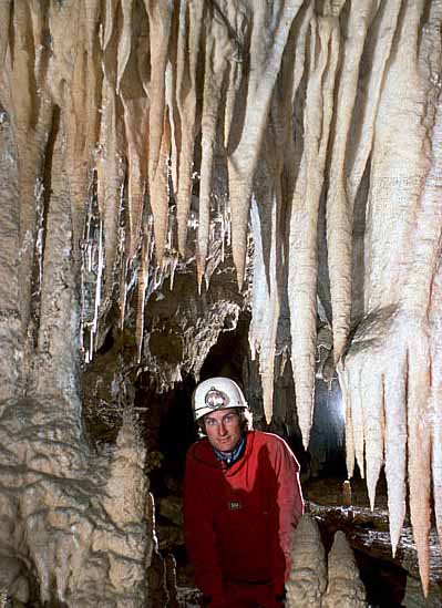Photo of caver under stalactites