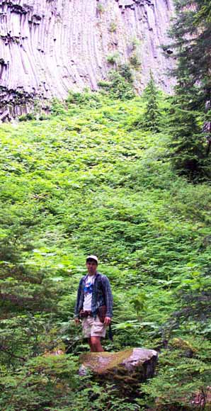 photo of geologist standing in front of dikes