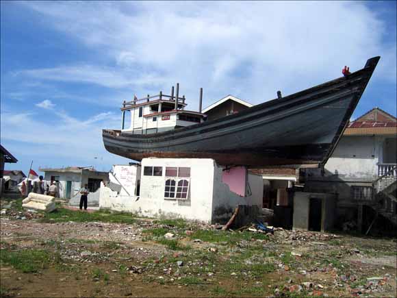 Photo of a fishing boat perched on top of a small building
