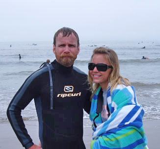 photo of people on the beach; Andy is in a wetsuit
