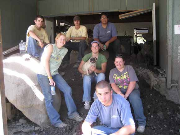 Photo of muddy teenagers with proud smiles