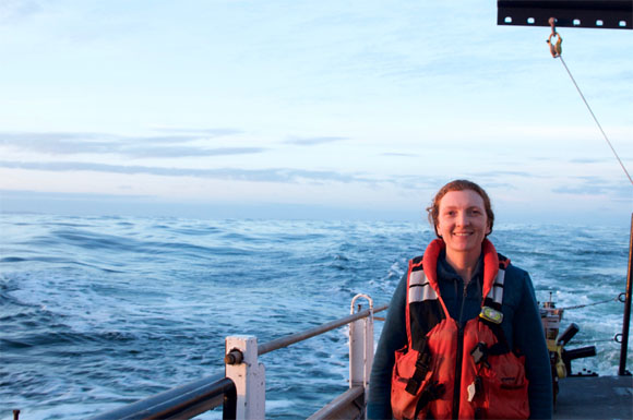 Photo of Summer on deck at sea with her PFD