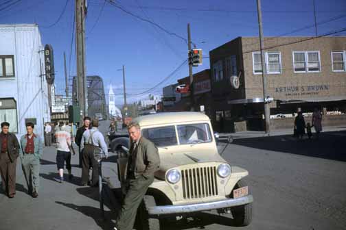 photo, Bill leaning on the fender of a jeep on Cushman Street