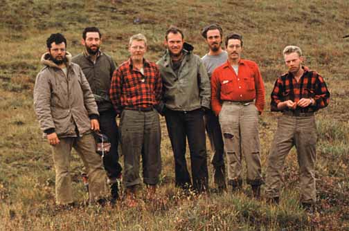 photo, seven men posing in a meadow