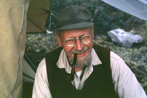 photo, closeup of Bill at spike camp smoking his pipe